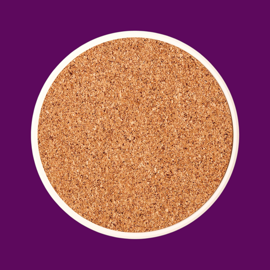 Reverse side of a round ceramic coaster showing the non-slip tan cork base to protect furniture from scratches.