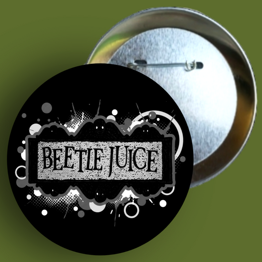 Handmade 1.5-inch round Beetlejuice movie logo pin featuring high-contrast neon green and purple colors from The Fright Factory, NOLA.