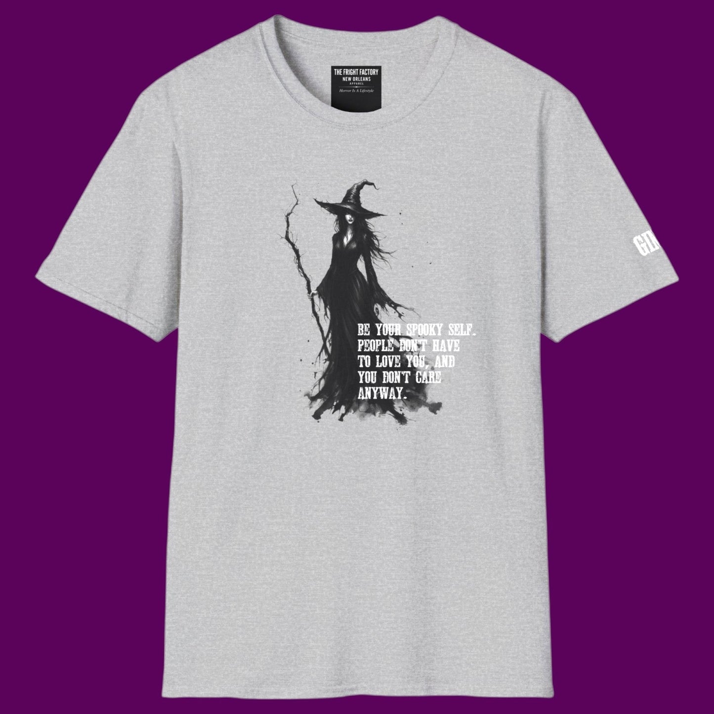 Gothic witch graphic t-shirt featuring a detailed illustration of a witch holding a staff, surrounded by the quote 'Be your spooky self. People don't have to love you, and you don't care anyway.' Designed and sold in The Fright Factory NOLA gothic gift shop.