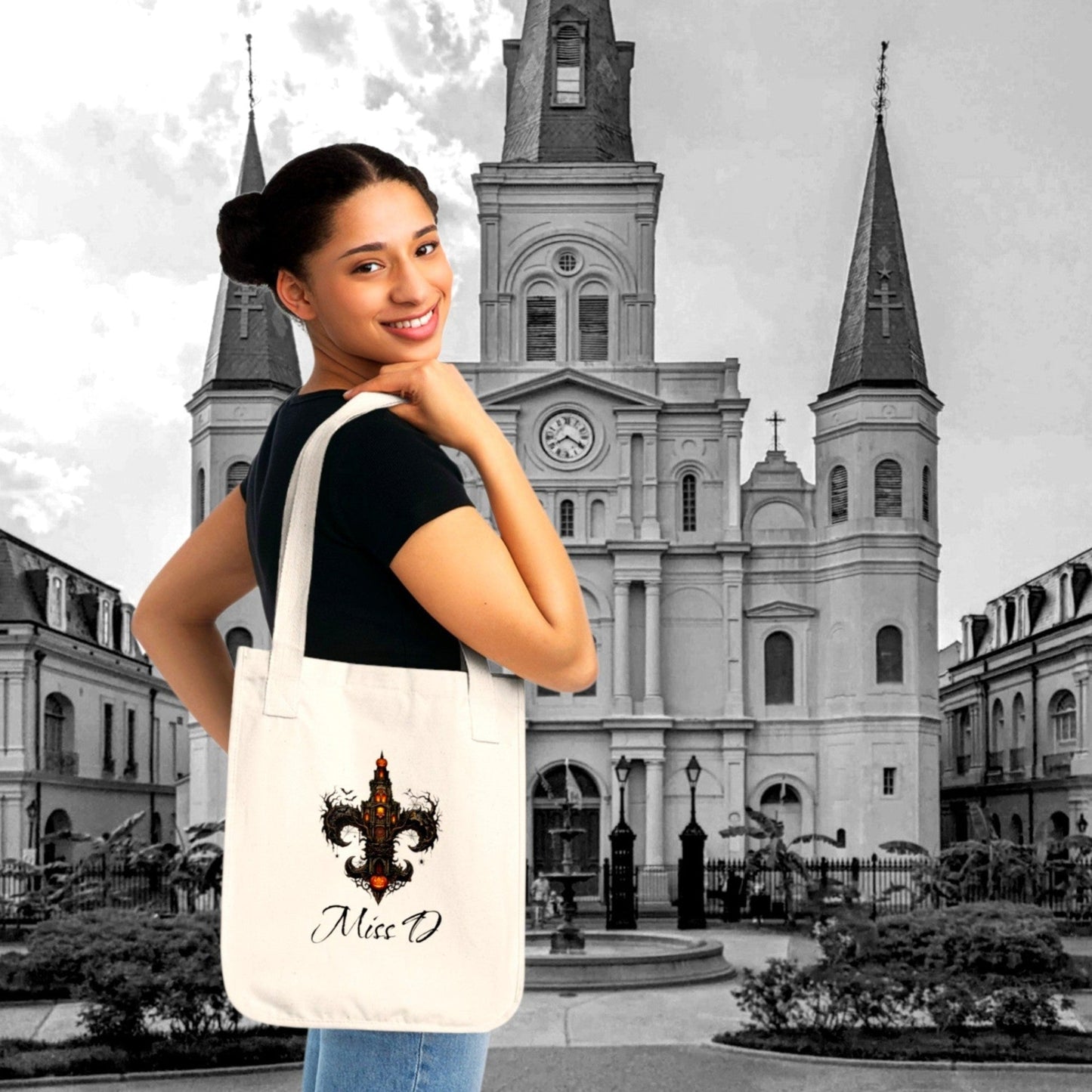 Model carrying our custom Gothic Fleur-de-Lis Tote features durable organic cotton & personalized text. From The Fright Factory, NOLA Halloween gift shop.