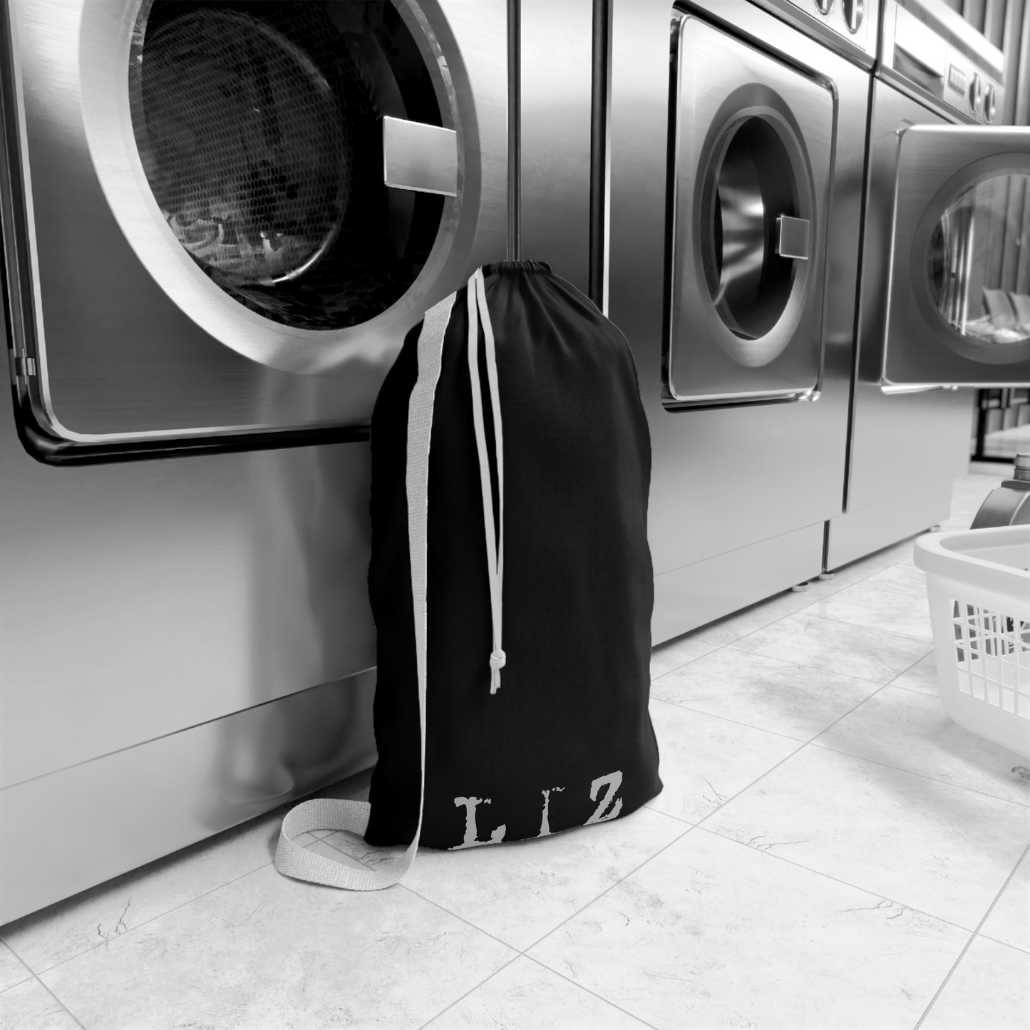 Customized large alien invasion themed laundry bag standing in a laundry room, styled as spooky sci-fi home decor and dorm room essentials. Designed in The Fright Factory New Orleans Gift Sop.