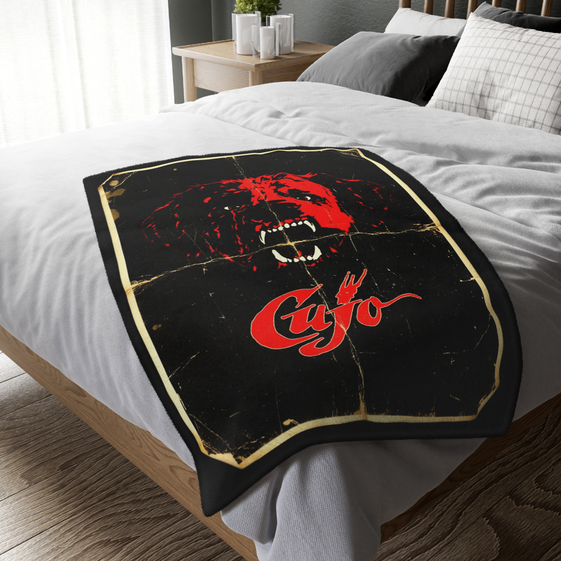 Personalized Cujo poster horror-themed blanket draped over a bed next to a movie night setup. Found in The Frght Factory, New Orleans.