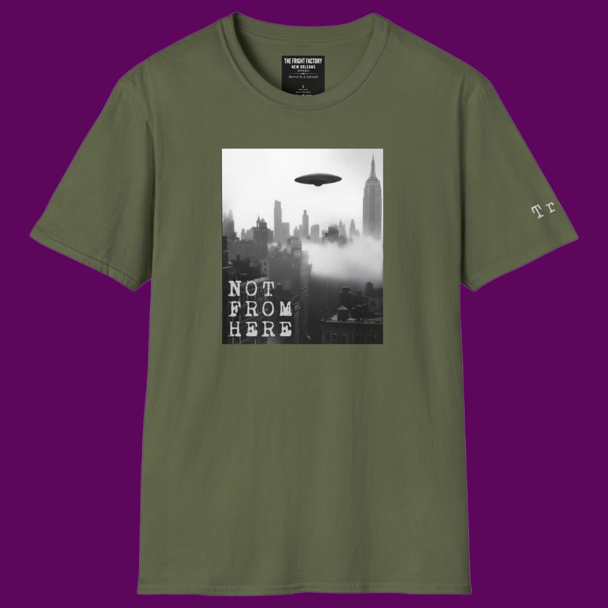 Olive green t-shirt featuring a vintage UFO sighting over a foggy city skyline with 'Not From Here' text, by The Fright Factory New Orleans.