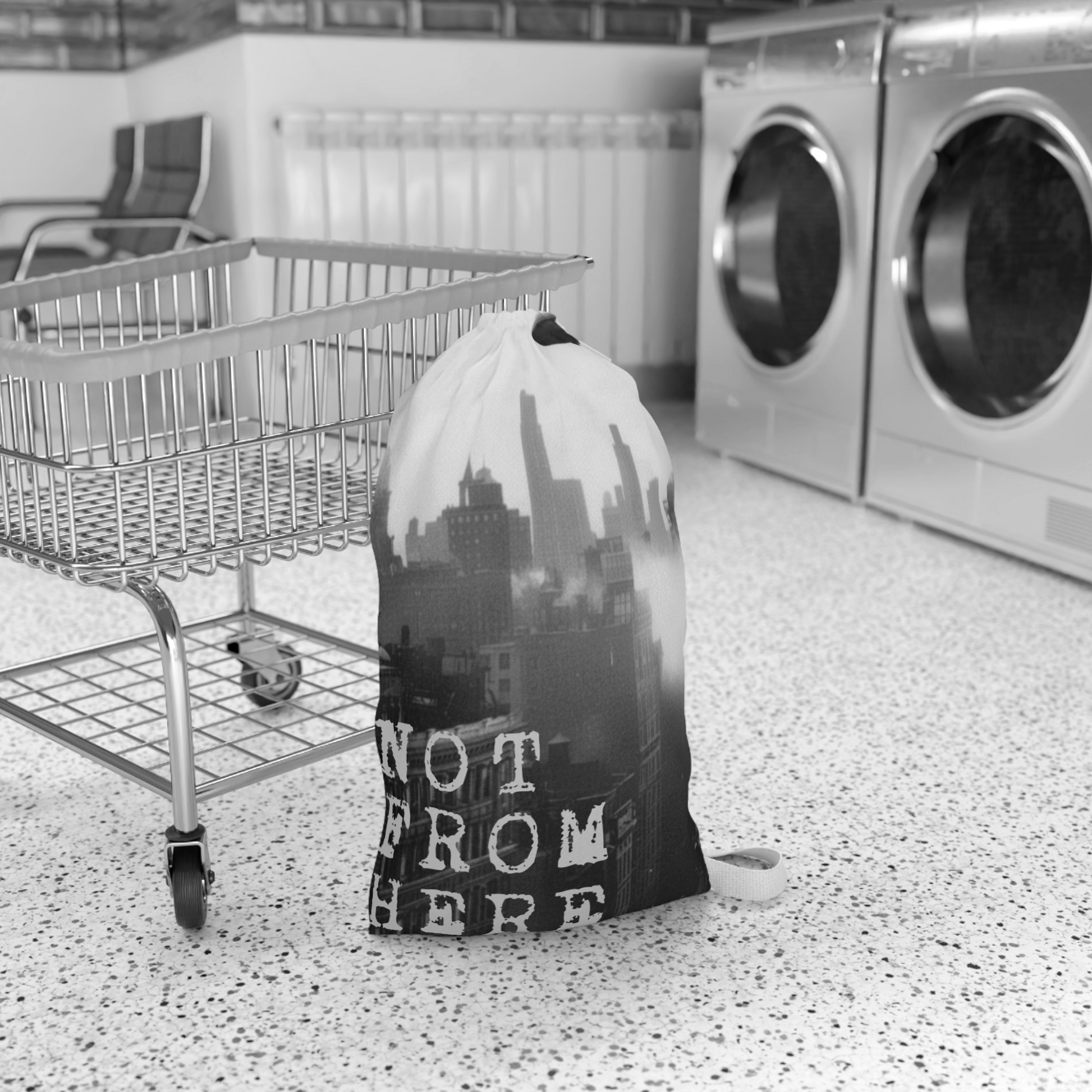 A large alien invasion themed laundry bag standing in a laundrymat, styled as spooky sci-fi home decor and dorm room essentials. Designedand sold in The Fright Factory New Orleans gift shop.