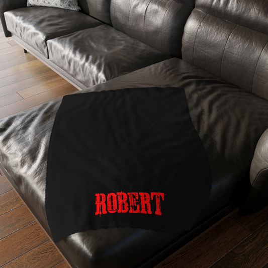 Personalized Cujo poster horror-themed blanket draped over a living room sofa next to a movie night setup. Found in The Frght Factory, New Orleans.