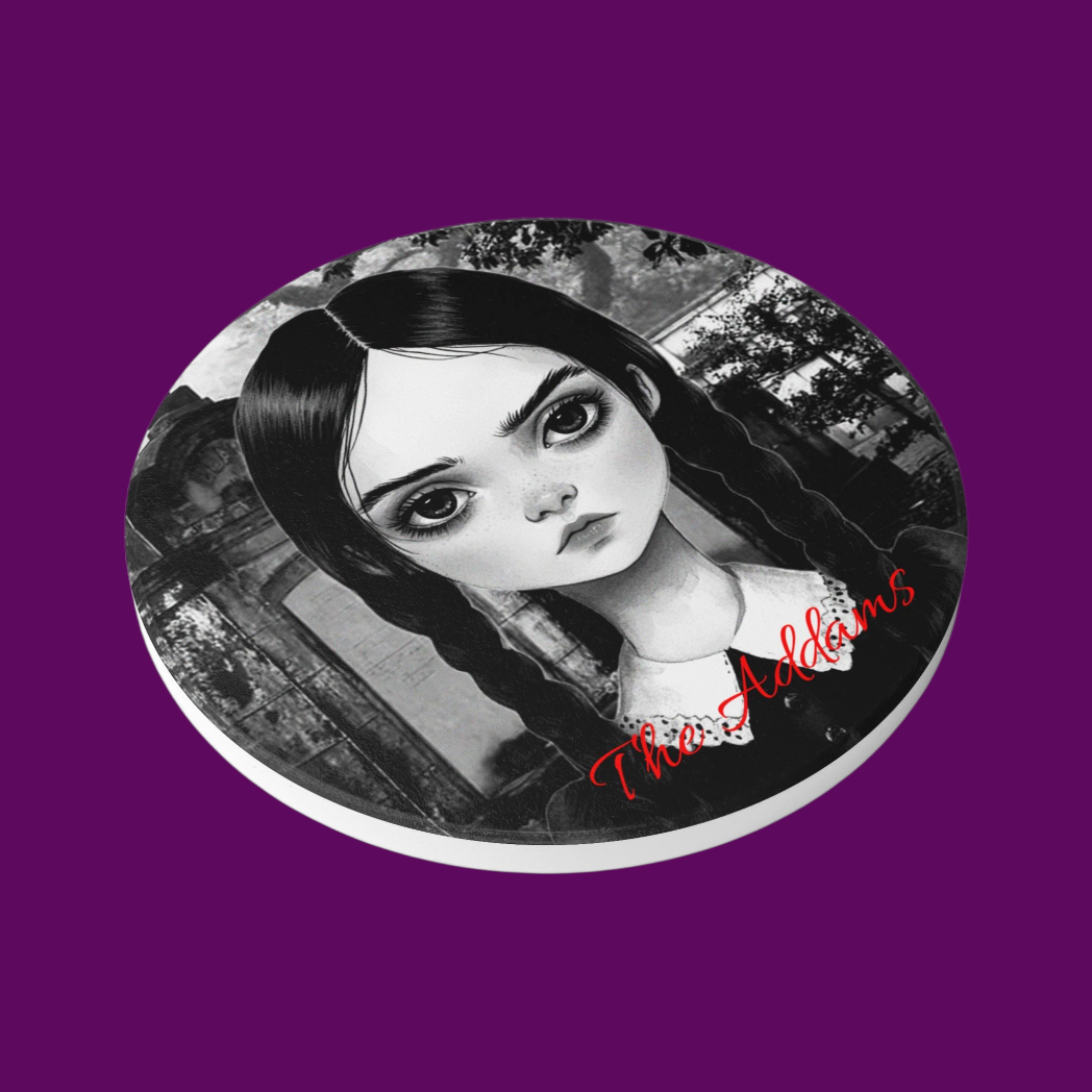 Close-up of a white ceramic coaster with a black minimalist illustration of Wednesday Addams and gothic filigree.