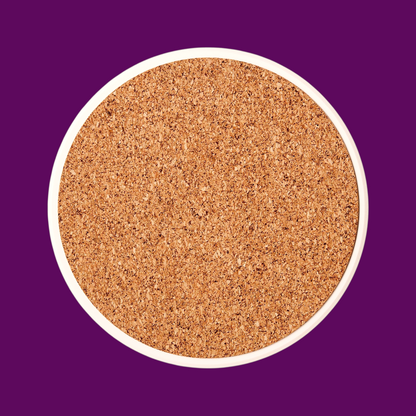 Reverse side of a round ceramic coaster showing the non-slip tan cork base to protect furniture from scratches.